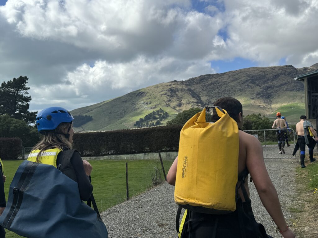 Carrying gear across the field before coasteering